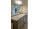 Bathroom vanity with a granite countertop and modern fixtures at 1116 Caloosa Ridge Way, Babson Park, FL 33827