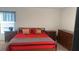 Bedroom with a large bed, dressers, and simple decor at 1116 Caloosa Ridge Way, Babson Park, FL 33827