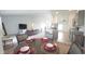 Cozy dining area with a round table set for four, adjacent to a spacious living room and modern kitchen at 1116 Caloosa Ridge Way, Babson Park, FL 33827