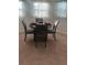 Intimate dining area featuring a round table with elegant place settings beneath softly lit windows at 1116 Caloosa Ridge Way, Babson Park, FL 33827