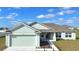 Inviting single-story home with a 2-car garage, well-maintained landscaping, and a charming covered entry at 1116 Caloosa Ridge Way, Babson Park, FL 33827