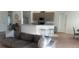 Open-concept kitchen with a breakfast bar, stainless steel appliances, and seamless flow to the living room at 1116 Caloosa Ridge Way, Babson Park, FL 33827
