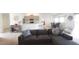 Open-concept living space with comfortable seating, stylish decor, and a view into the modern kitchen and dining area at 1116 Caloosa Ridge Way, Babson Park, FL 33827