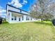 Spacious backyard with healthy grass, trees, and a patio under the eaves at 12791 Westside Village Loop, Windermere, FL 34786