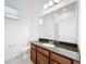 Well-lit bathroom featuring a vanity with a granite countertop and a large mirror at 12791 Westside Village Loop, Windermere, FL 34786