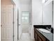 Bathroom with a sink and a view into a carpeted bedroom at 12791 Westside Village Loop, Windermere, FL 34786