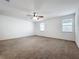 Spacious bedroom with neutral carpet, ceiling fan and windows allowing for ample natural light at 12791 Westside Village Loop, Windermere, FL 34786
