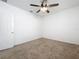 Bedroom featuring neutral carpet, a ceiling fan, fresh paint and a door to the hallway at 12791 Westside Village Loop, Windermere, FL 34786