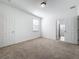 Bright bedroom with plush carpeting, white walls, and a window with blinds at 12791 Westside Village Loop, Windermere, FL 34786