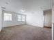 Bright bonus room with neutral carpet, three windows offering natural light, and fresh white paint at 12791 Westside Village Loop, Windermere, FL 34786
