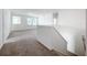 View of the bonus room features neutral carpet, fresh paint, and stairs with white railing at 12791 Westside Village Loop, Windermere, FL 34786