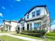 Charming two-story house showcases a landscaped yard and covered entryway, with beautiful curb appeal at 12791 Westside Village Loop, Windermere, FL 34786