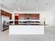Modern kitchen featuring an island with sink, stainless steel fridge, and lots of cabinets at 12791 Westside Village Loop, Windermere, FL 34786