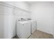 Laundry area featuring a washer, dryer, and overhead wire shelving at 12791 Westside Village Loop, Windermere, FL 34786