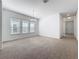 Inviting living room with neutral carpeting and three large windows allowing for natural light at 12791 Westside Village Loop, Windermere, FL 34786