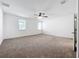 Main bedroom with carpet, multiple windows and ceiling fan at 12791 Westside Village Loop, Windermere, FL 34786