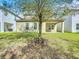 Backyard view of house with covered patio and tree for shade at 12880 Westside Village Loop, Windermere, FL 34786