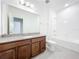 Bathroom features a long vanity with granite counters, and a shower/tub combo at 12880 Westside Village Loop, Windermere, FL 34786