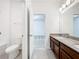 Bathroom with double sink vanity, granite counters, tile floor, and shower/tub combo at 12880 Westside Village Loop, Windermere, FL 34786