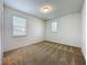 Bright, carpeted bedroom with natural light from two windows at 12880 Westside Village Loop, Windermere, FL 34786
