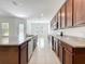 Spacious kitchen featuring a large center island with granite countertops and stainless steel appliances at 12880 Westside Village Loop, Windermere, FL 34786