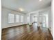 Open living room with hardwood floors, white walls, large windows offering plenty of natural light and open floorplan at 12880 Westside Village Loop, Windermere, FL 34786