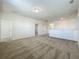 Upstairs loft with neutral carpet, white walls, a view of the hallway, the bathroom, and a bedroom at 12880 Westside Village Loop, Windermere, FL 34786