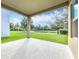 Covered patio looking out onto a green lawn and pond view at 12880 Westside Village Loop, Windermere, FL 34786