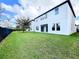Spacious backyard features lush green grass and a partial fence at 12971 Westside Village Loop, Windermere, FL 34786