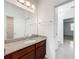 Bathroom with granite countertops and a view into the bedroom and closet at 12971 Westside Village Loop, Windermere, FL 34786