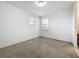 Bright bedroom features neutral carpet, two windows offering ample natural light, and fresh white walls at 12971 Westside Village Loop, Windermere, FL 34786