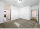 A bright bedroom with neutral carpeting and multiple doorways at 12971 Westside Village Loop, Windermere, FL 34786