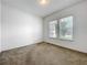 Bright bedroom with neutral carpet, two bright windows with view, and white trim at 12971 Westside Village Loop, Windermere, FL 34786