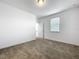 Bedroom with neutral carpet, white walls, one window with blinds, and a door at 12971 Westside Village Loop, Windermere, FL 34786