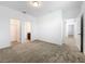 Spacious bedroom with neutral carpet and multiple doors leading to various rooms at 12971 Westside Village Loop, Windermere, FL 34786