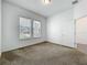 Spacious bedroom with neutral carpet, two bright windows, and white trim at 12971 Westside Village Loop, Windermere, FL 34786