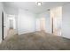 Spacious bedroom with neutral carpet, multiple doors leading to a walk-in closet and other rooms at 12971 Westside Village Loop, Windermere, FL 34786