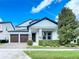 Inviting two-story home with manicured landscaping, stone accents, and a two-car garage at 12971 Westside Village Loop, Windermere, FL 34786