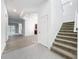 Bright foyer with tiled flooring, staircase, and views into living spaces at 12971 Westside Village Loop, Windermere, FL 34786