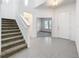 Bright foyer with tiled floor, staircase, and glass-paneled office doors at 12971 Westside Village Loop, Windermere, FL 34786