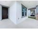Inviting front porch featuring a window, stylish front door, and serene view of the backyard at 12971 Westside Village Loop, Windermere, FL 34786