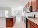 Open kitchen boasts stainless appliances and a view into the dining and living areas at 12971 Westside Village Loop, Windermere, FL 34786