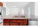 Kitchen island with granite countertops and stainless steel sink and dishwasher at 12971 Westside Village Loop, Windermere, FL 34786