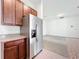 Spacious kitchen features stainless steel refrigerator, granite countertops and lots of cabinet space at 12971 Westside Village Loop, Windermere, FL 34786