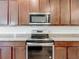 A stainless steel stove and microwave are installed in this kitchen at 12971 Westside Village Loop, Windermere, FL 34786