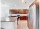 Bright kitchen features an island, stainless steel refrigerator and ample cabinet space at 12971 Westside Village Loop, Windermere, FL 34786