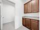 Laundry room showcases tile flooring, built-in cabinets, and washer dryer hookups at 12971 Westside Village Loop, Windermere, FL 34786