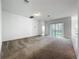 Spacious living room features sliding glass doors and neutral carpeting at 12971 Westside Village Loop, Windermere, FL 34786