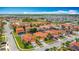 Wide aerial view of a residential neighborhood featuring pools, lakes, and lush landscaping at 131 Stella Pass, Davenport, FL 33837