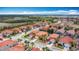Aerial view of residential neighborhood with orange tile roofs and lush greenery on a sunny day at 131 Stella Pass, Davenport, FL 33837
